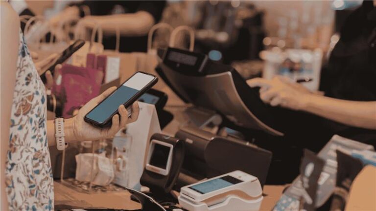 Retail customer making a contactless payment at a POS system, representing modern retail operations and POS technology for business management